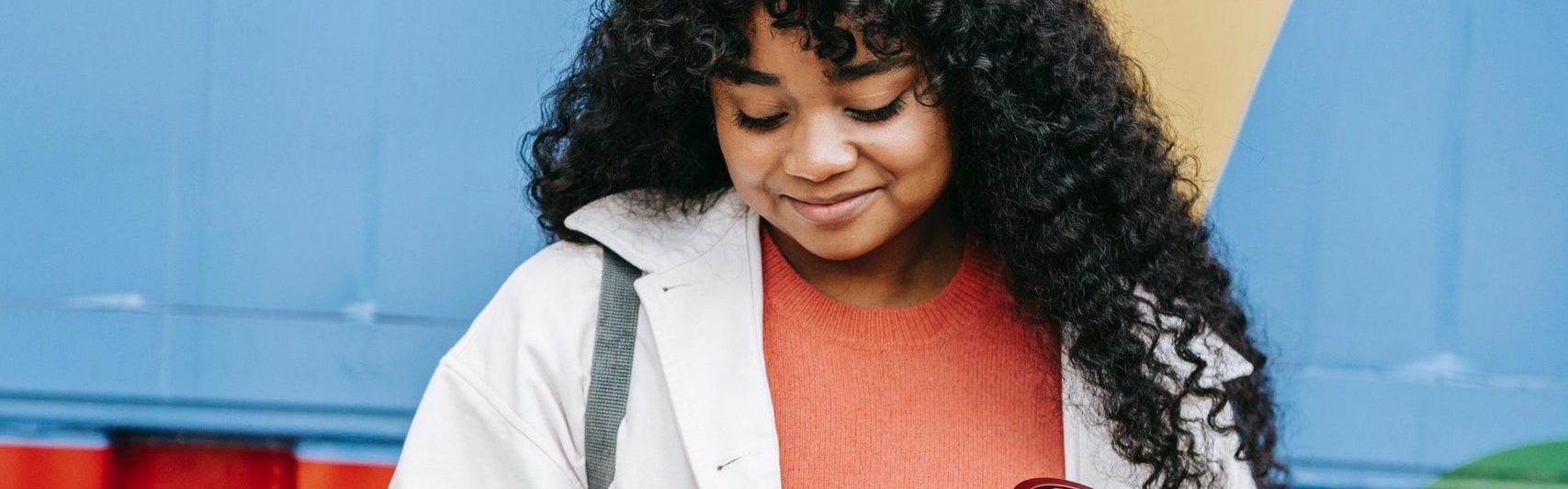 smiling-woman-looking-at-phone-scaled